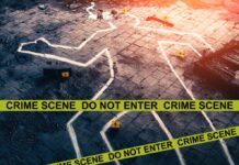 Crime scene with chalk outline and evidence markers.