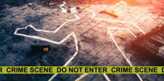 Crime scene with chalk outline and evidence markers.