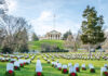 Cemetery with rows of tombstones and wreaths.