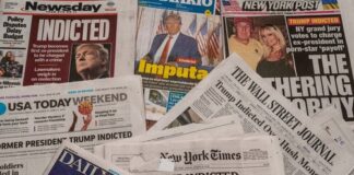 Newspapers with headlines about Donald Trumps indictment.