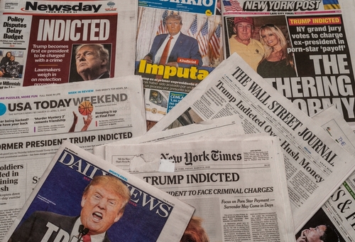 Newspapers with headlines about Donald Trumps indictment.