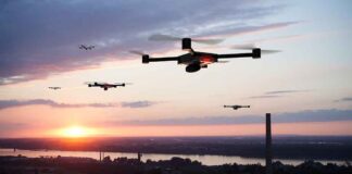 Drones flying over a landscape at sunset.