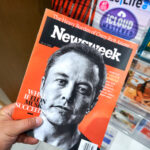 Person holding Newsweek magazine with Elon Musk cover.