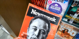 Person holding Newsweek magazine with Elon Musk cover.