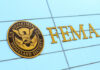 FEMA sign on building with Homeland Security seal.