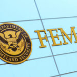 FEMA sign on building with Homeland Security seal.