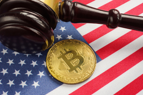 Gavel and Bitcoin on American flag background.