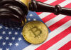 Gavel and Bitcoin on American flag background.