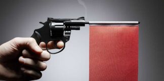 Gun with a red flag attachment, presented sideways.