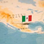 Mexican flag pin on a map of Mexico.