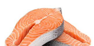 Two raw salmon steaks on a white background.