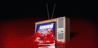 Vintage TV displaying Breaking News submerged in red liquid