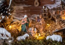 Nativity scene with Mary, Joseph, baby Jesus, and animals.