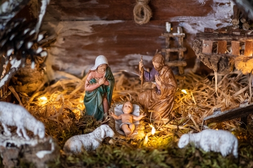 Nativity scene with Mary, Joseph, baby Jesus, and animals.