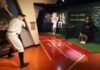 Wax figures of famous athletes in sports-themed museum display.