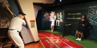 Wax figures of famous athletes in sports-themed museum display.