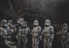 Clone troopers gathered in dark, atmospheric setting.