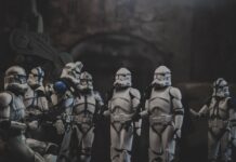 Clone troopers gathered in dark, atmospheric setting.