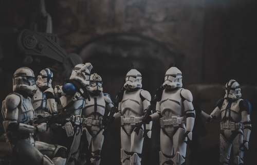 Clone troopers gathered in dark, atmospheric setting.