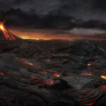 Erupting volcano with flowing lava under dark, stormy sky.