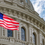 U.S. flag in front of the Capitol building.