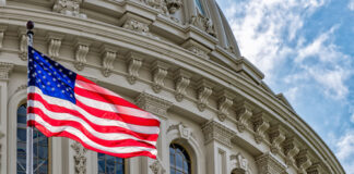 U.S. flag in front of the Capitol building.