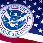 US Homeland Security emblem over American flag