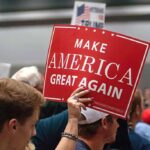 Person holding a Make America Great Again sign.