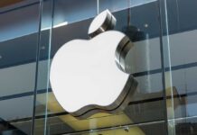 Large Apple logo on glass building facade.