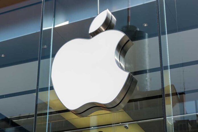 Large Apple logo on glass building facade.