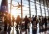 People standing in line at an airport terminal.