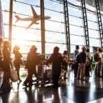 People standing in line at an airport terminal.