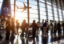 People standing in line at an airport terminal.