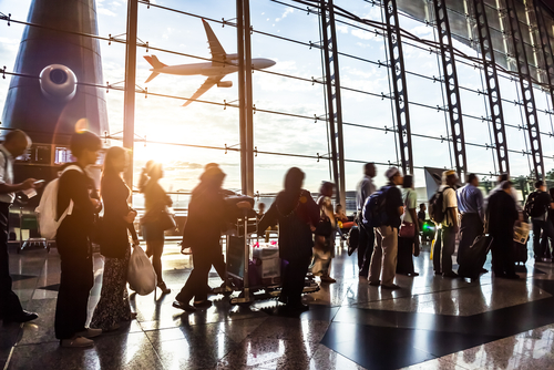 People standing in line at an airport terminal.