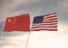 Chinese and American flags waving side by side.