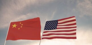 Chinese and American flags waving side by side.