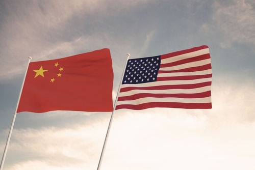 Chinese and American flags waving side by side.