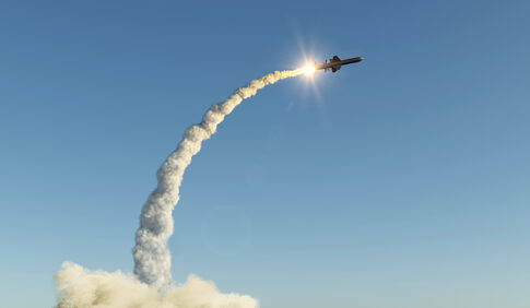 Missile launching into the sky with smoke trail.