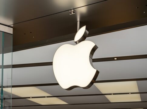 Illuminated Apple logo inside a store.