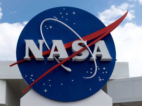 NASA logo outside building with blue sky background.