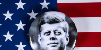 Button with John F. Kennedy on American flag background.