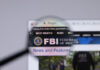 Website of FBI under magnifying glass.