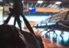 Empty airport terminal with empty seats and a backpack.