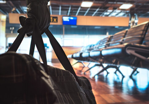 Empty airport terminal with empty seats and a backpack.