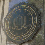 FBI seal on a building exterior wall.