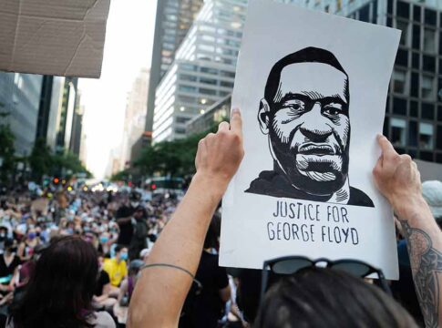 Person holding Justice for George Floyd sign at protest.