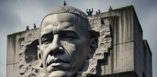 A large monument featuring a carved face and a crowd holding protest signs