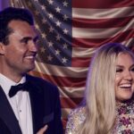 TPUSA Chapter DISSOLVES After Erika Kirk Visit… A smiling couple in formal attire standing in front of an American flag backdrop