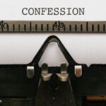 Typewriter with paper showing the word confession.