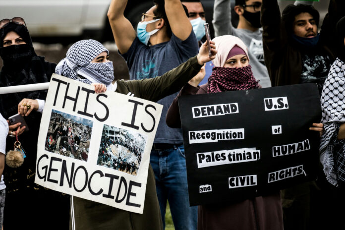 Protesters holding signs at a rally